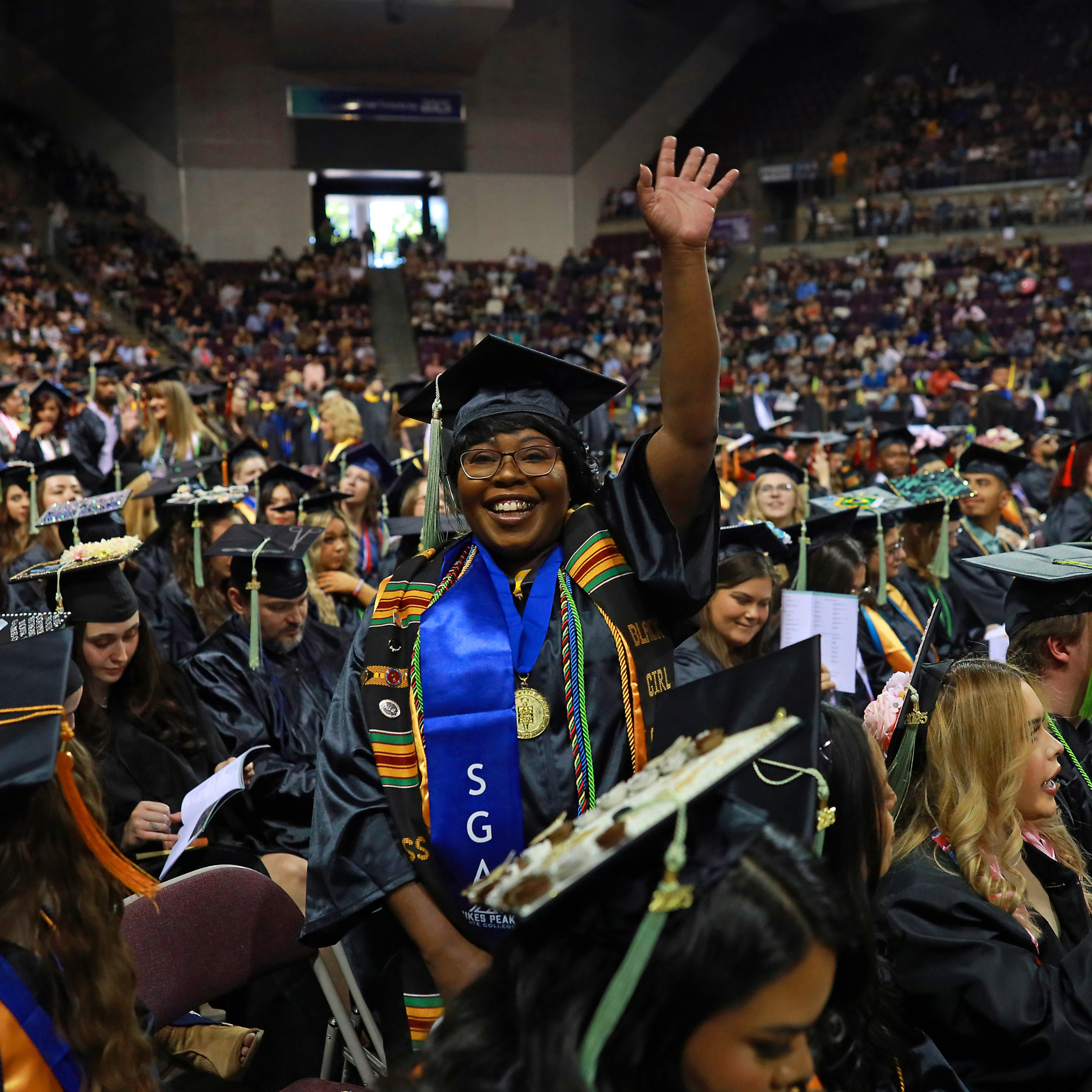 graduate waving to family