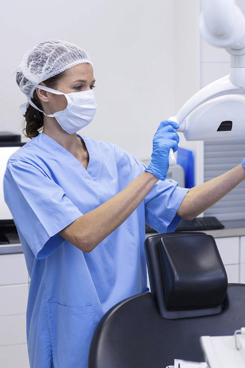 dental hygiene student using a machine